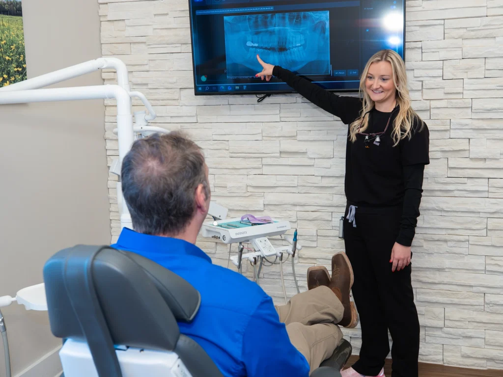 Dr. Simmons pointing to an x-ray with a patient - Dentist in Lawrenceburg, TN.